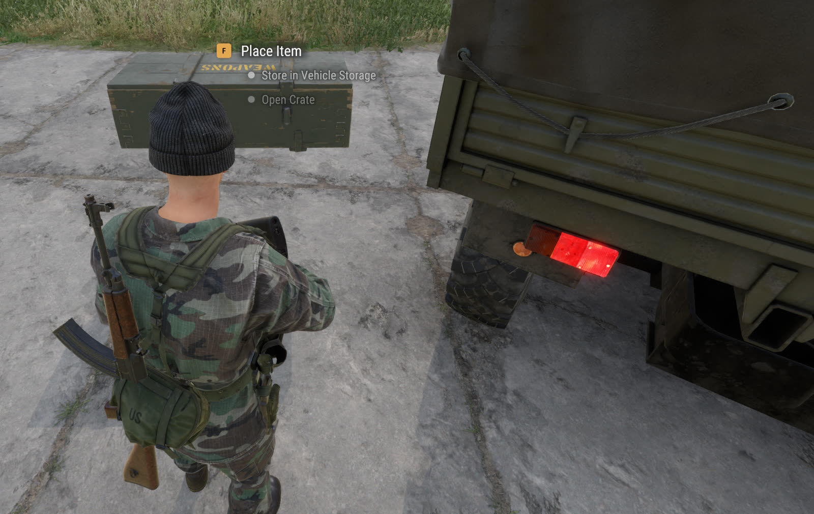 A player carrying a loot crate beside a truck